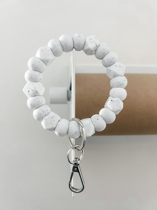 solid tone bracelet keychain in speckled white with small hexagons