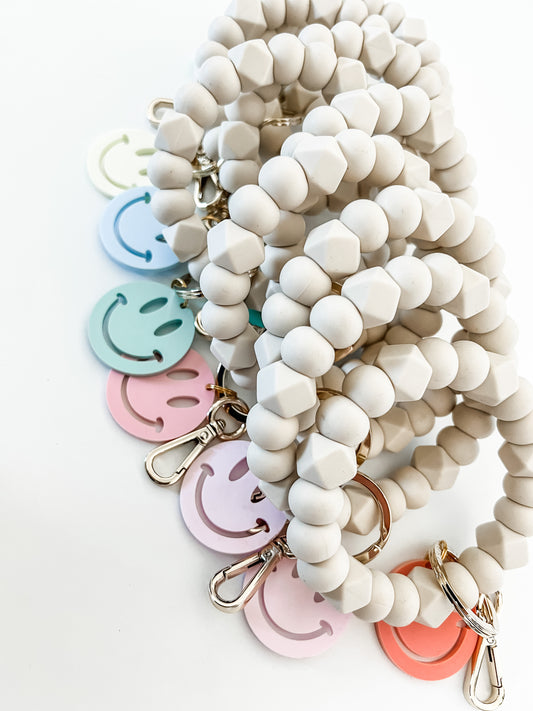 all ivory bracelet keychain with smiley charm