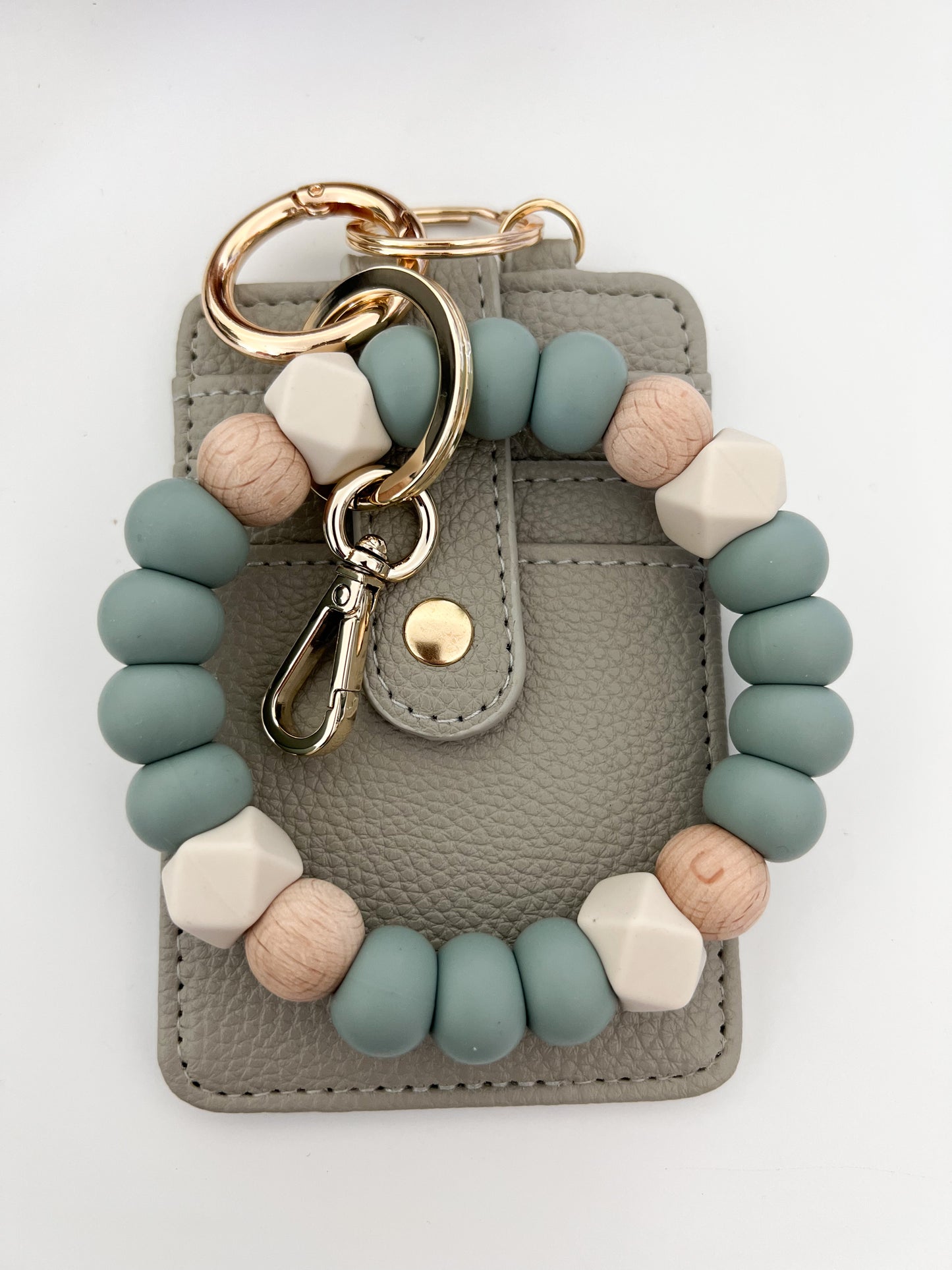 muted blue bracelet keychain with creamy grey card holder