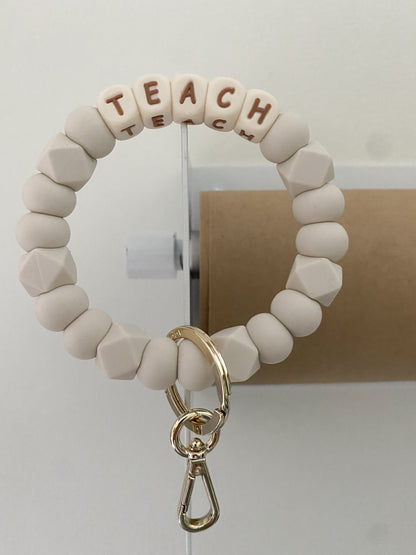 ivory and camel TEACH + MAMA bracelet keychains