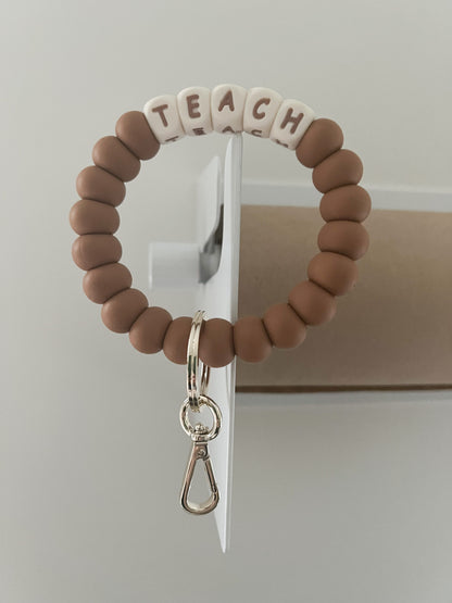 TEACH (ivory) and hazelnut bracelet keychain