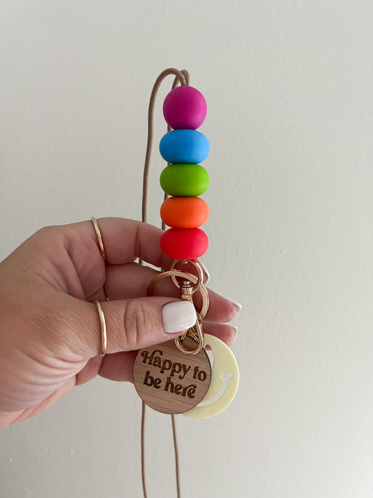 good life oblong neon lanyard with happy to be here & smiley charms