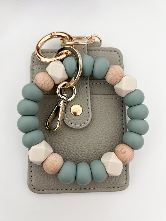 muted blue bracelet keychain with creamy grey card holder