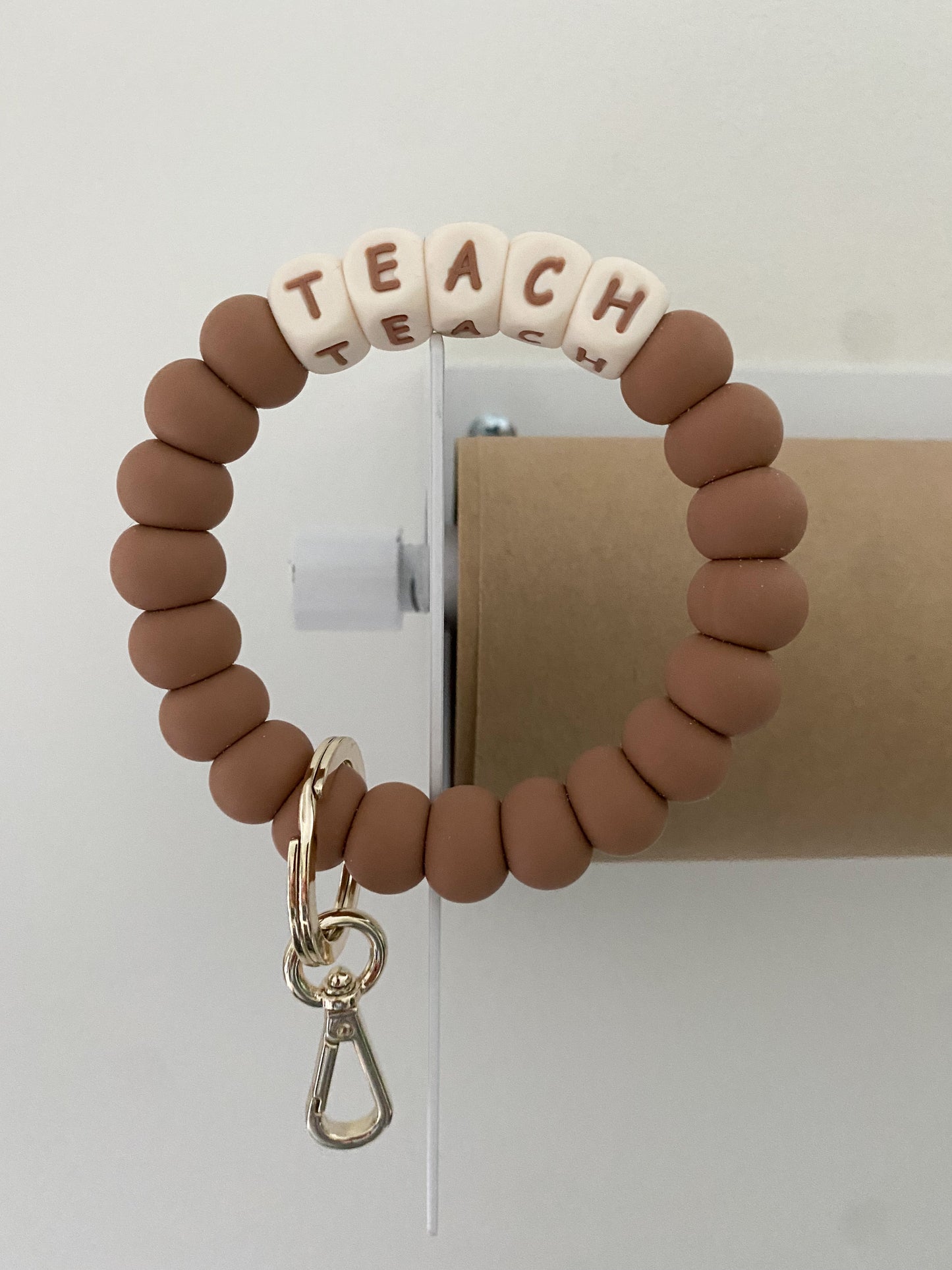 ivory and camel TEACH + MAMA bracelet keychains