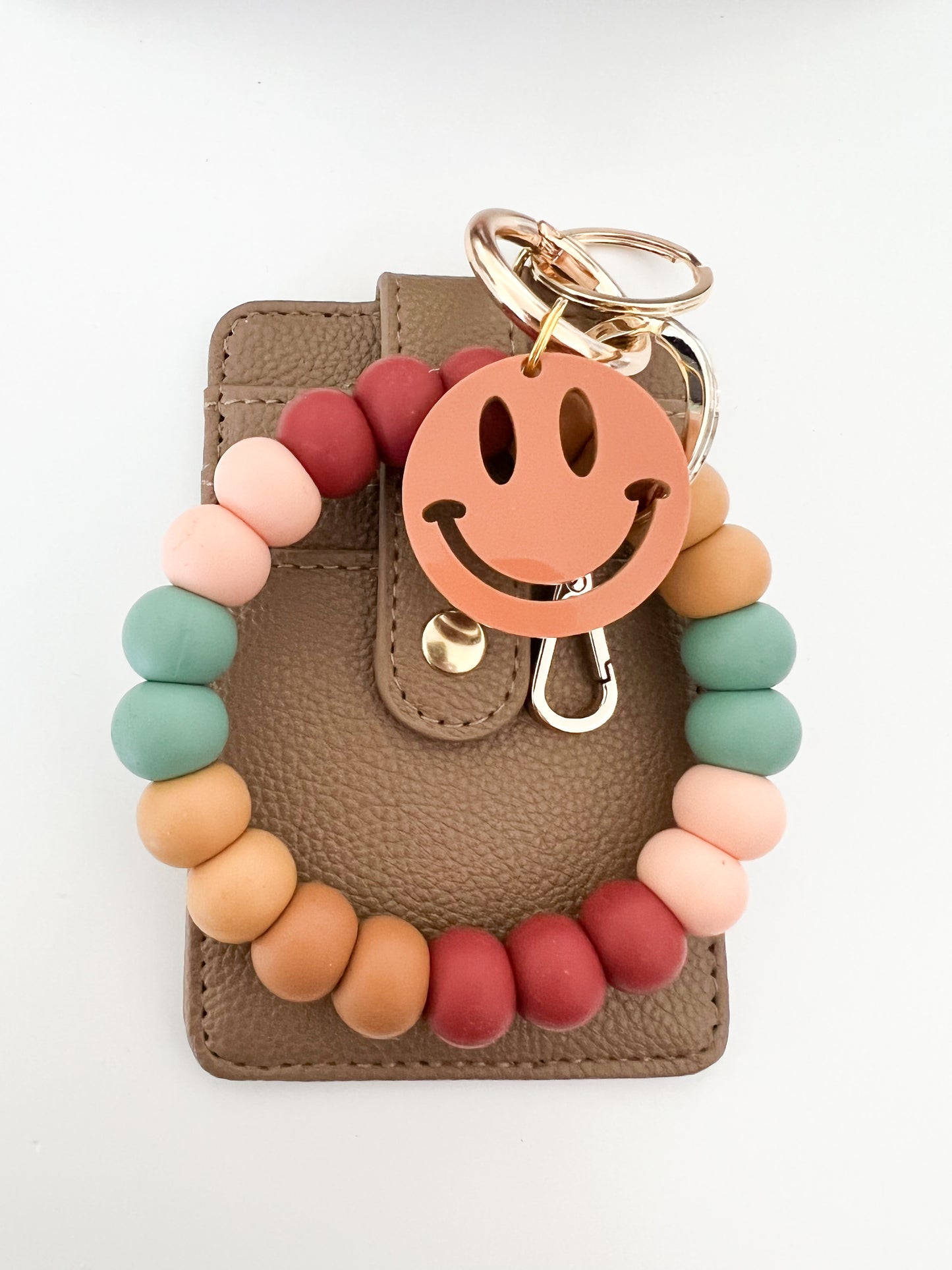 muted rainbow bracelet keychain with brown card holder